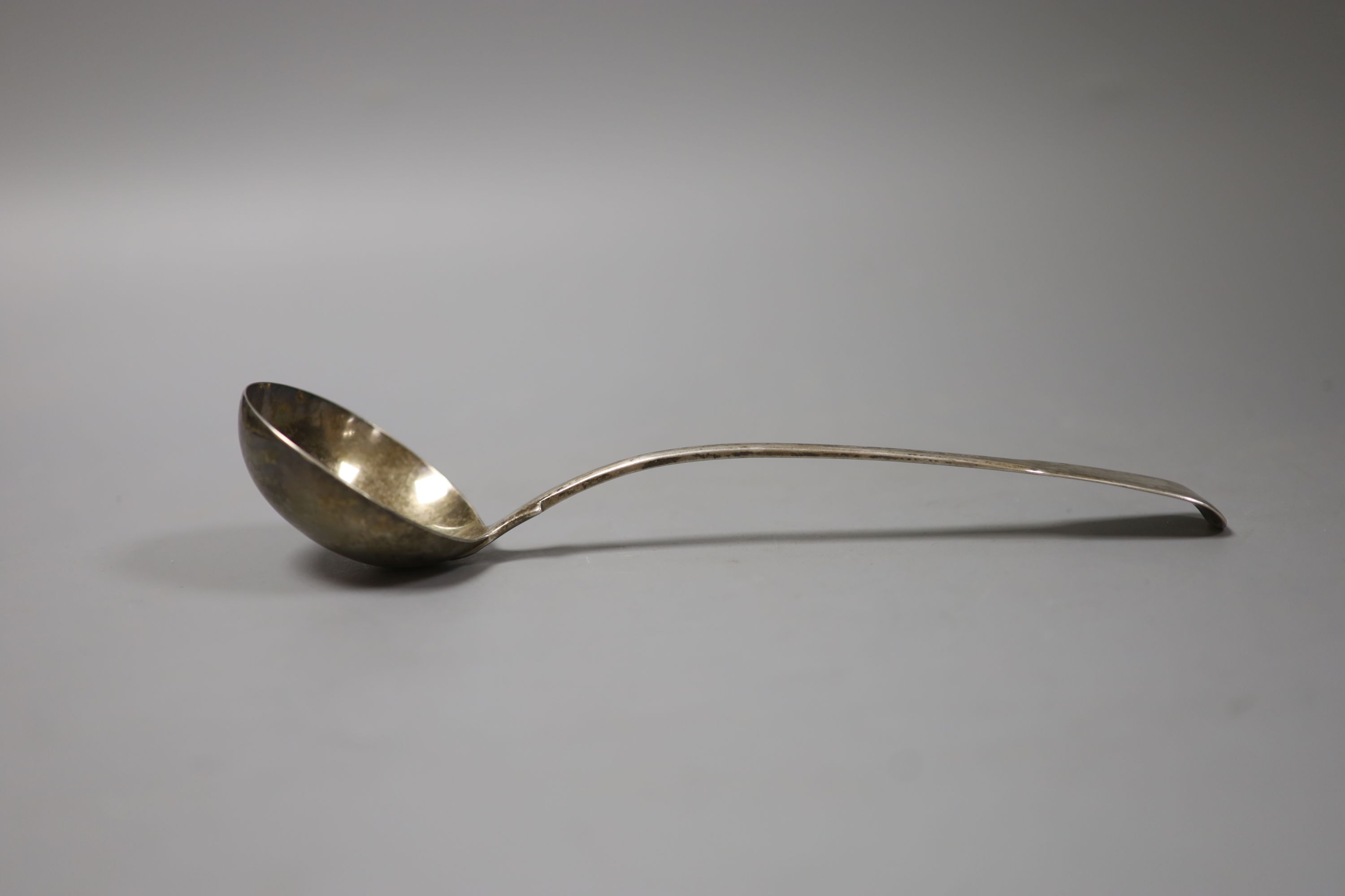 A George III silver fiddle pattern soup ladle, London, 1812, 26.6cm, a Victorian silver goblet, George Angell, London, 1871, 13cm and an early Victorian silver mounted glass travelling inkwell.